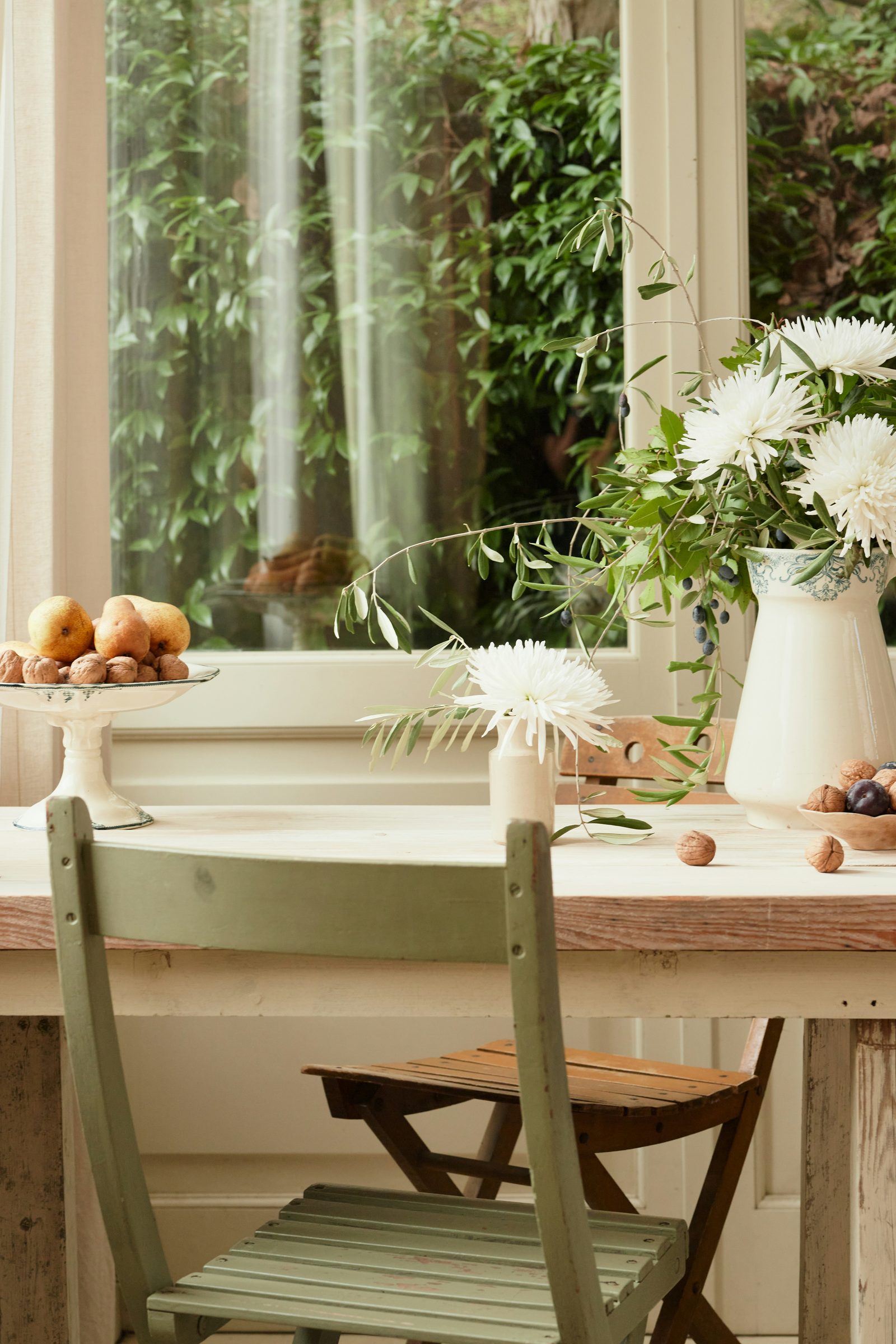 Older woman sitting peacefully on her front porch in soft afternoon light